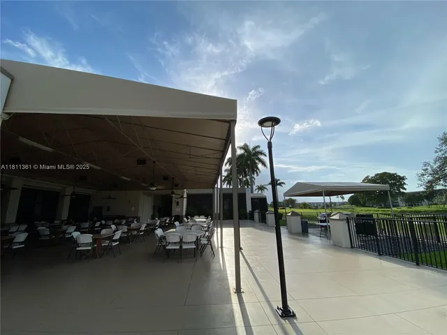a view of a patio with table and chairs and potted plants