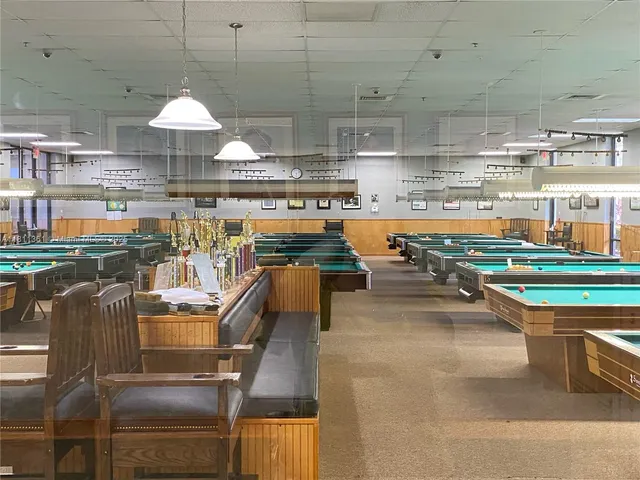 a view of multiple houses with a yard and a garage