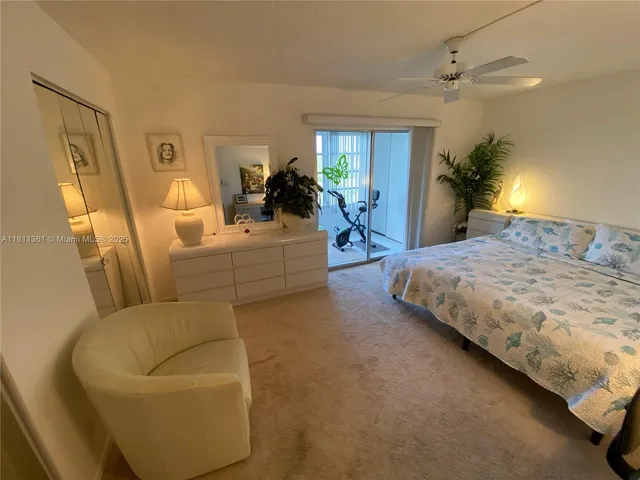 a bedroom with a bed couch and window