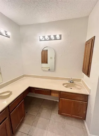 a bathroom with a tub a sink and a mirror