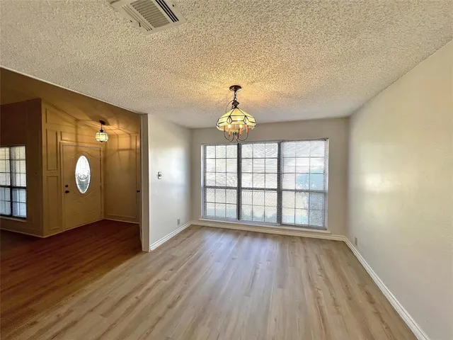 a large kitchen with stainless steel appliances granite countertop a sink and cabinets