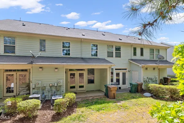 a front view of a house with a yard and outdoor seating