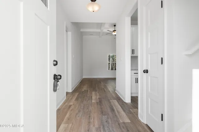 a view of a room with wooden floor