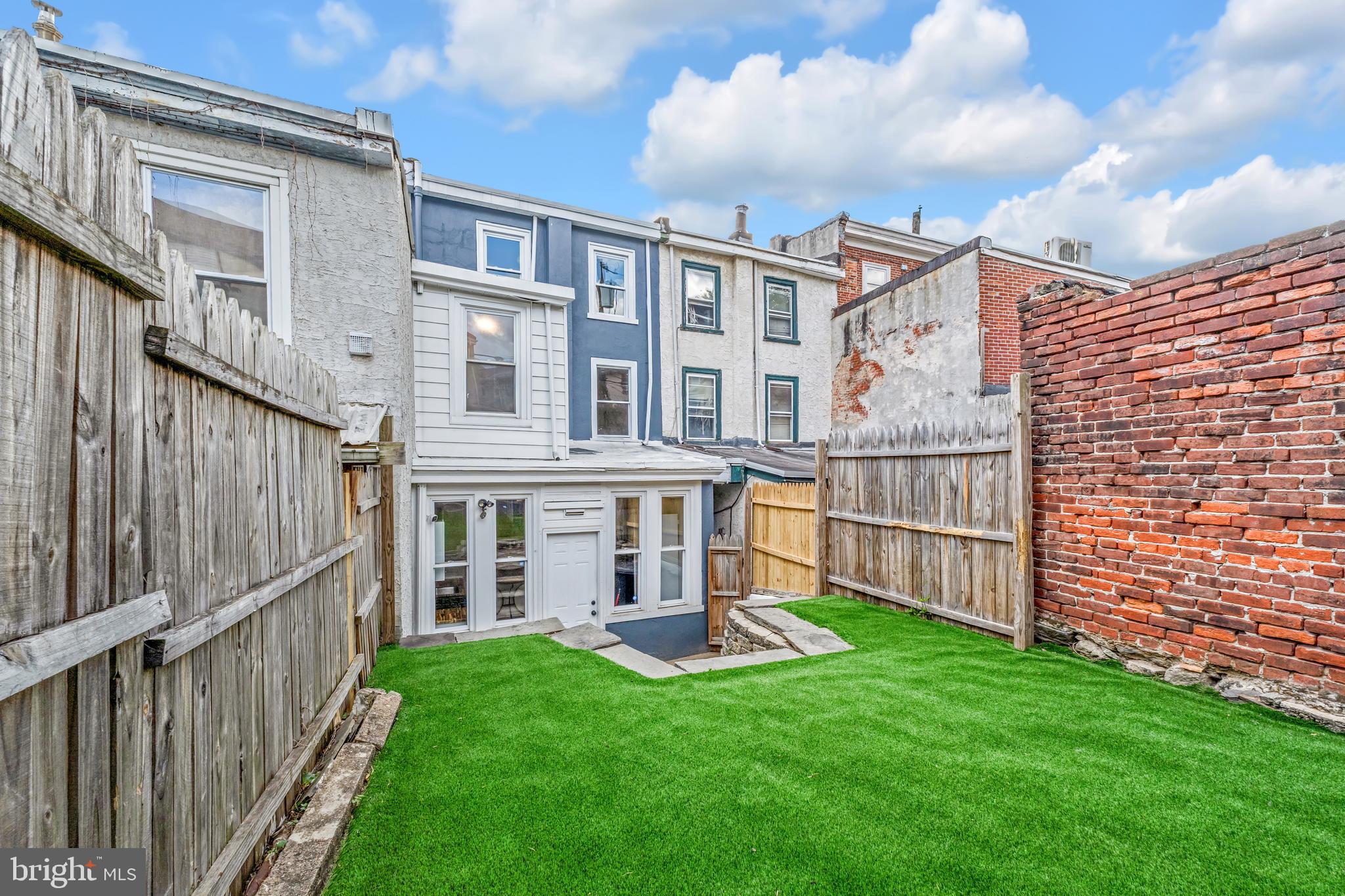 4413 Baker Street Philadelphia, PA 19127 - Photo 1 of 30 a view of a brick house with a yard