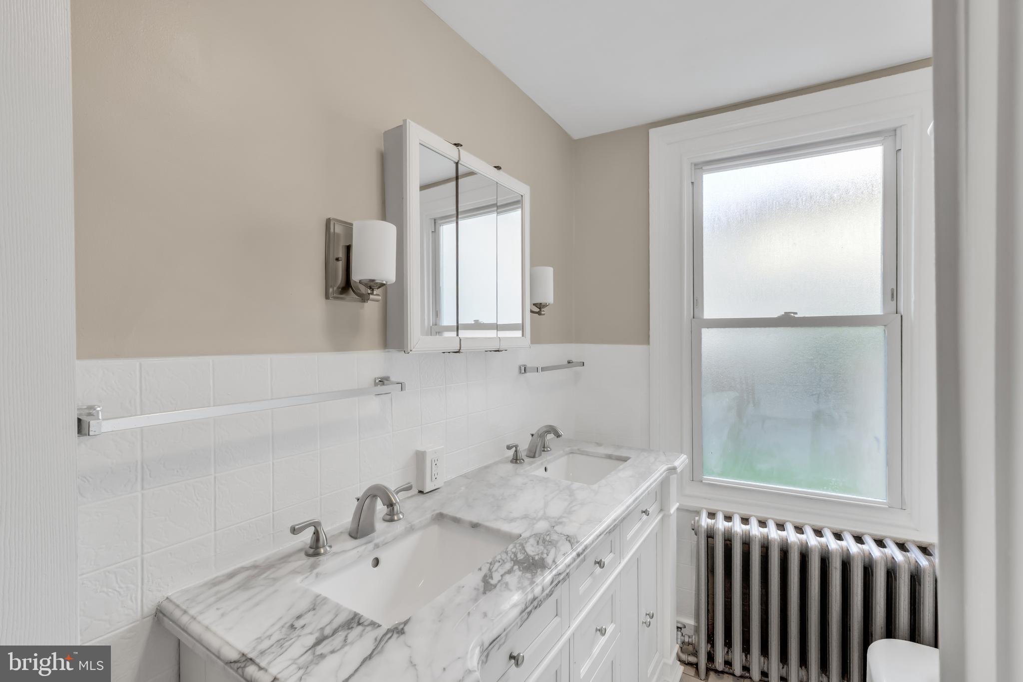 4413 Baker Street Philadelphia, PA 19127 - Photo 19 of 30 a bathroom with a sink and a mirror