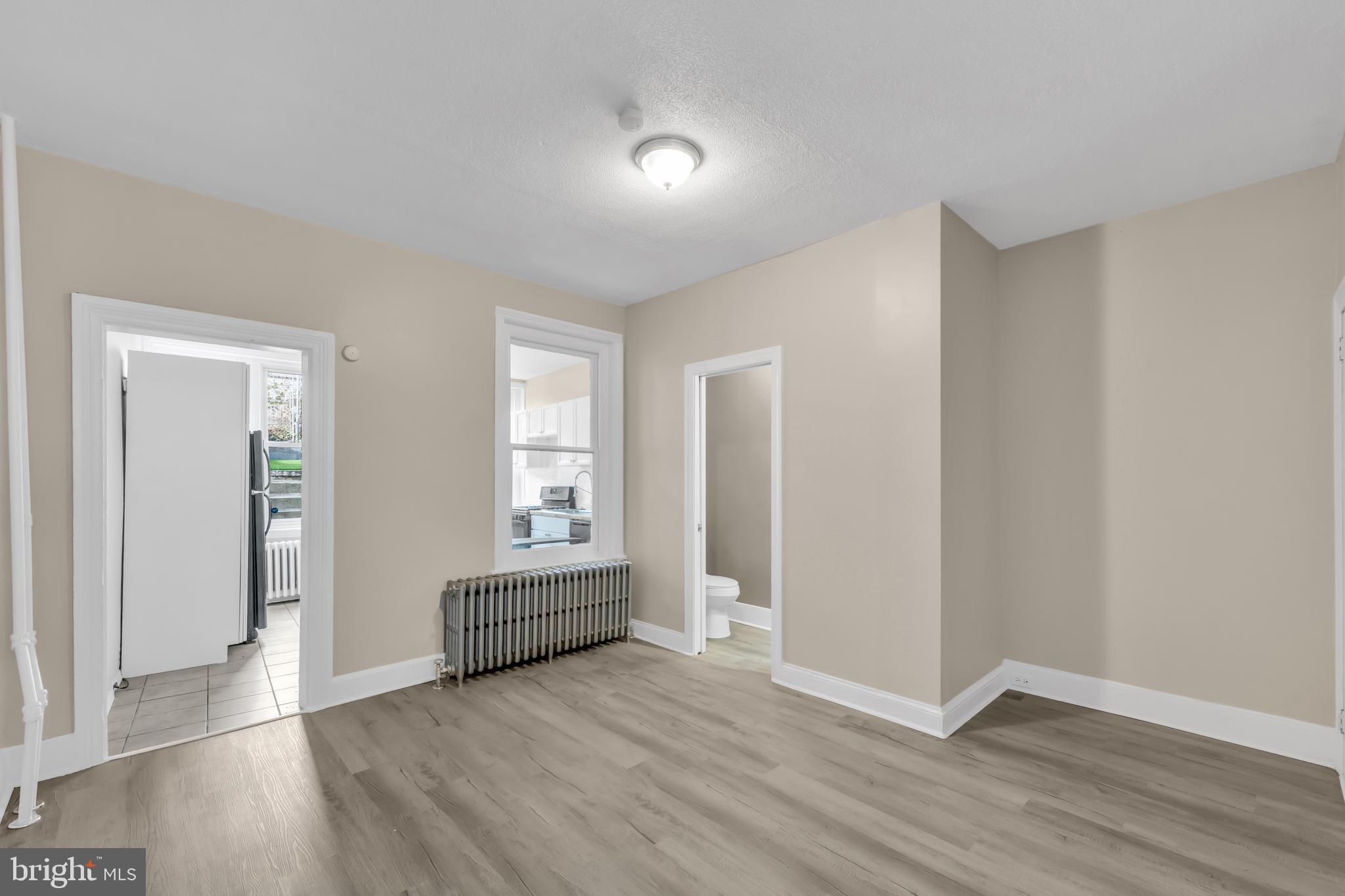 4413 Baker Street Philadelphia, PA 19127 - Photo 5 of 30 an empty room with wooden floor and windows