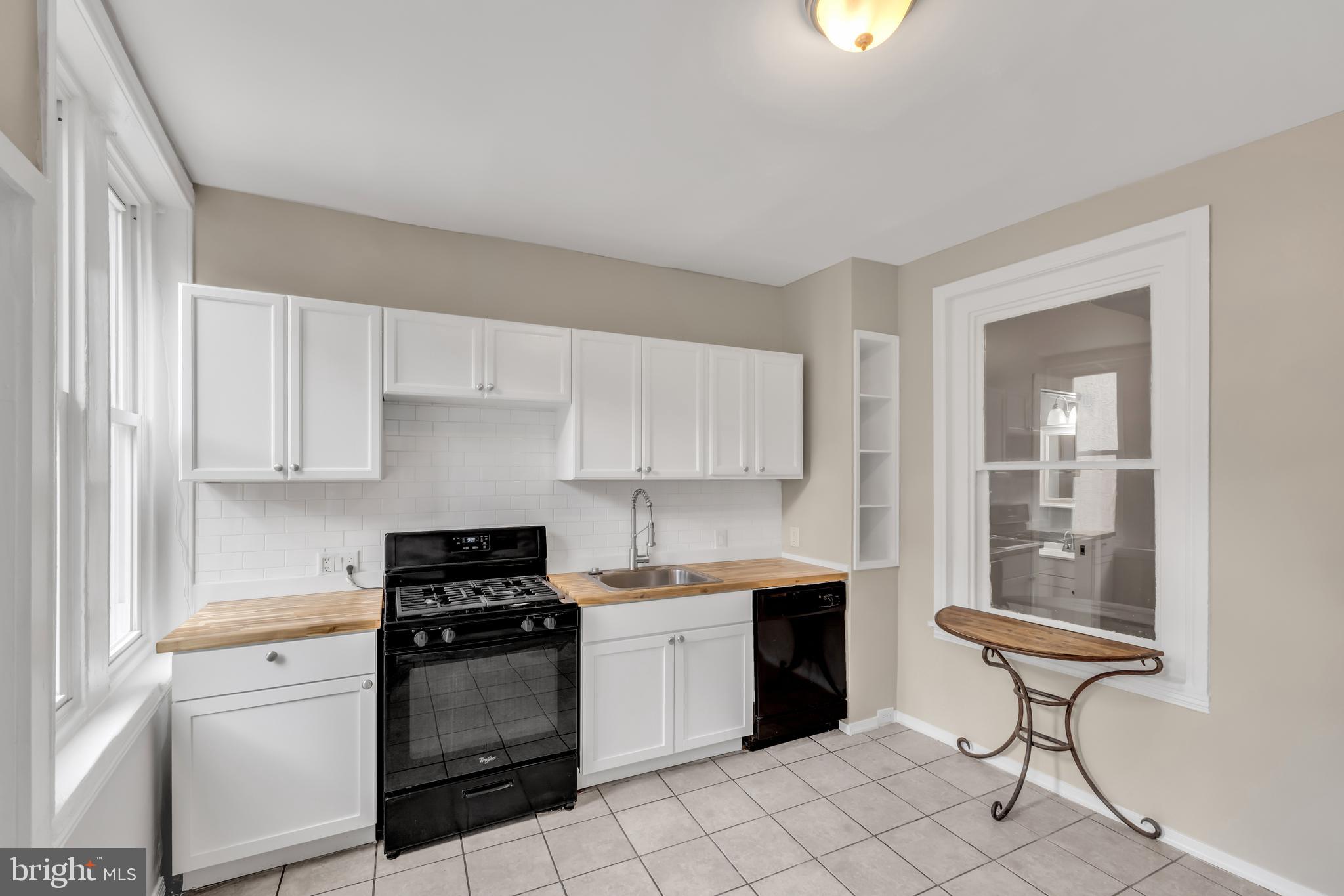 4413 Baker Street Philadelphia, PA 19127 - Photo 7 of 30 a kitchen with a stove a sink and a refrigerator