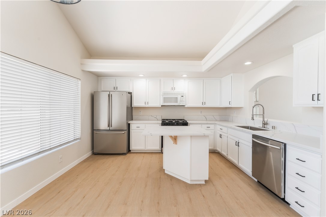 8872 Chapman Point Las Vegas, NV 89129 - Photo 6 of 29 Culinary delights await in this bright kitchen with vaulted ceilings and ample counter space.