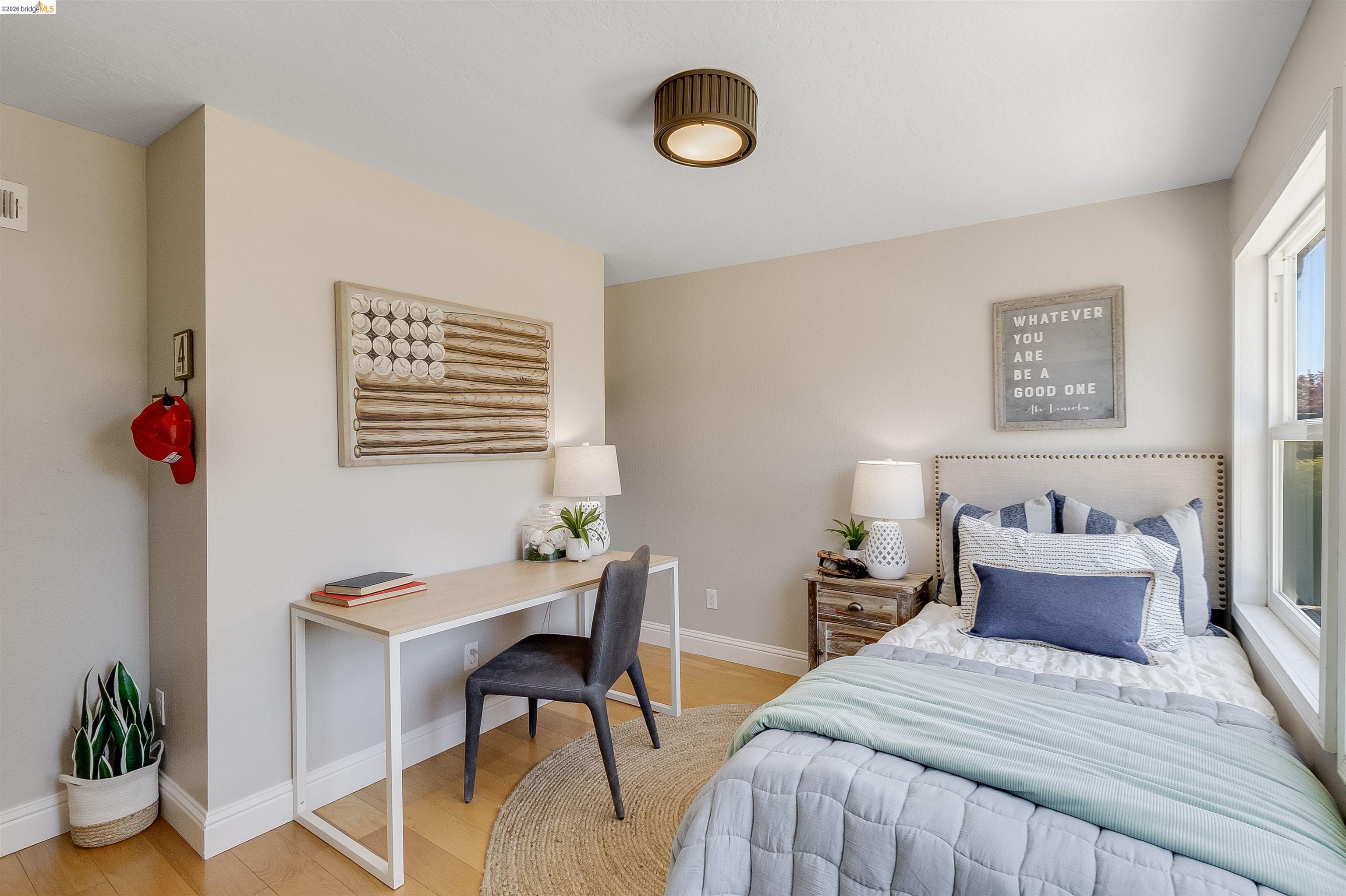 346 Valley View Road Pleasant Hill, CA 94523 - Photo 36 of 57 Bedroom featuring light wood-finish flooring, neutral wall tones, a large window, a ceiling-mounted light fixture, and white baseboards