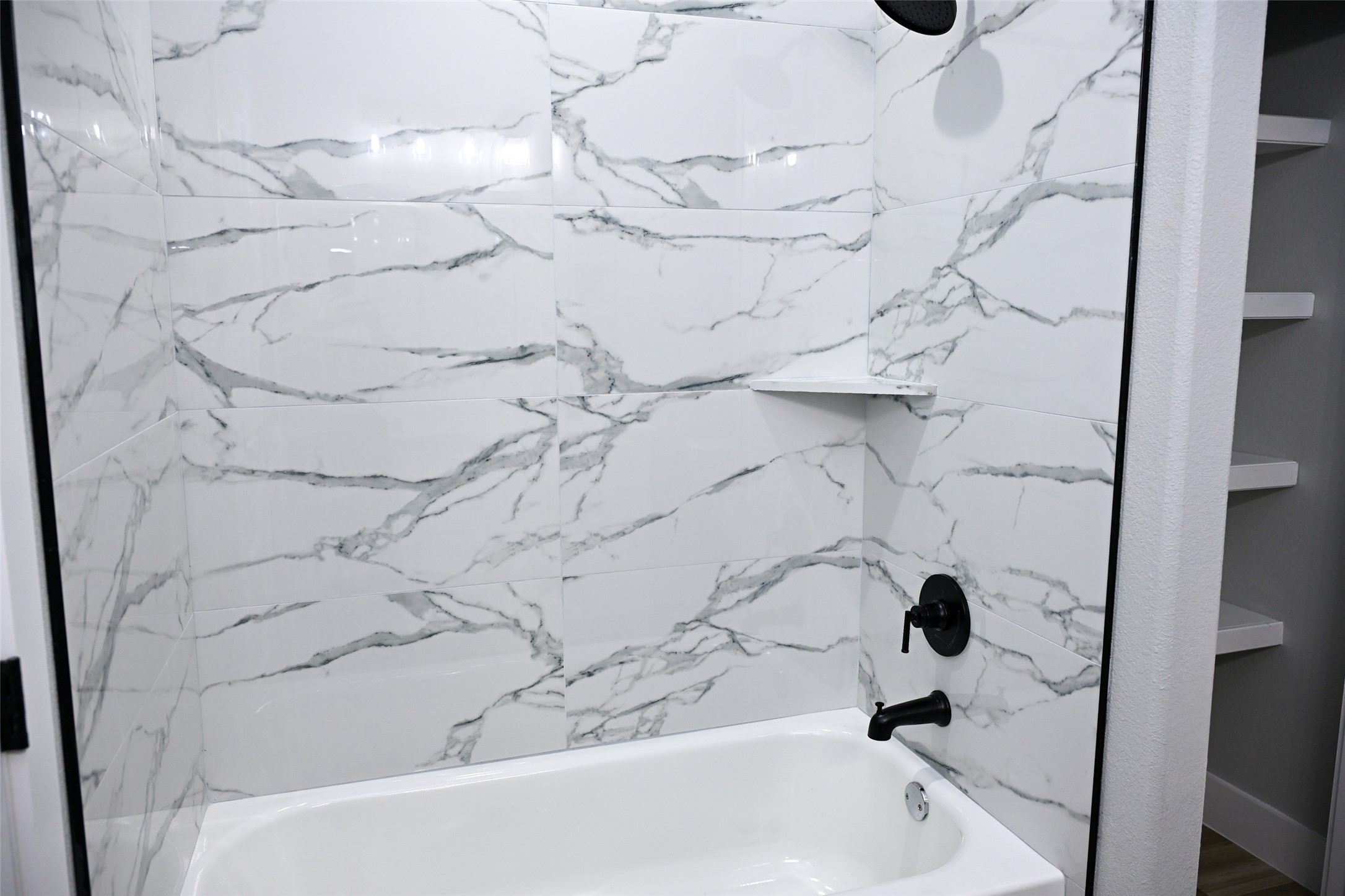 516 North Hackberry Avenue Luling, TX 78648 - Photo 12 of 36 Bathroom featuring a combined bath / shower with marble appearance