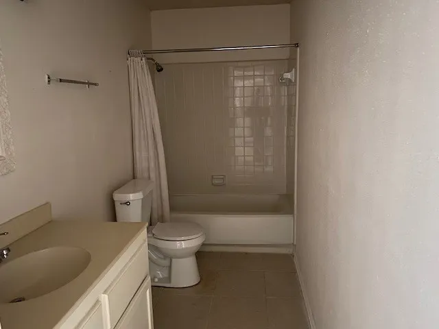 a white toilet sitting next to a bath tub