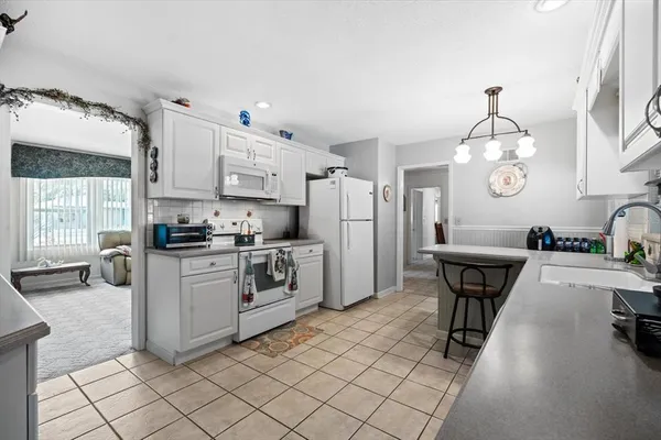 a kitchen with a sink cabinets and window