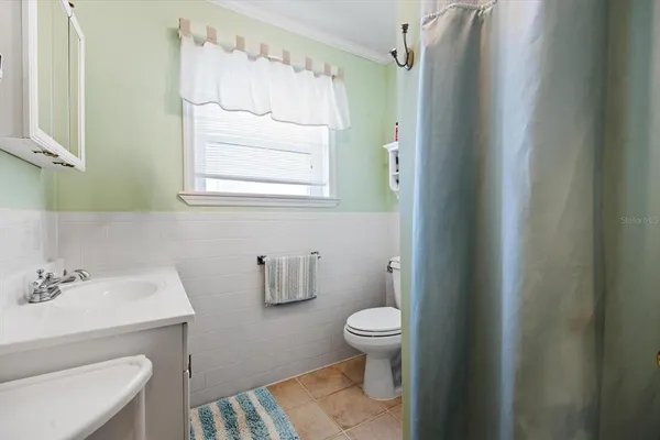 a bathroom with a sink toilet and vanity