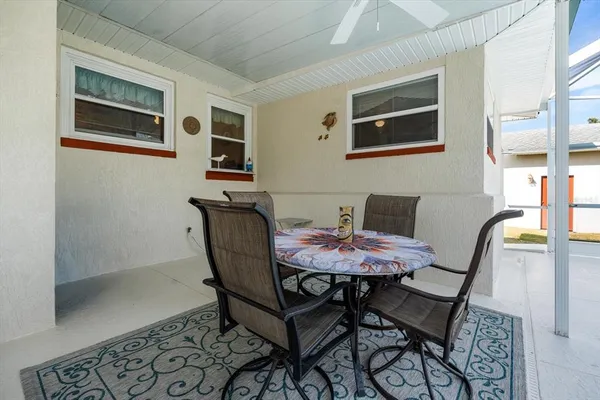 a view of a dining room with furniture and a window