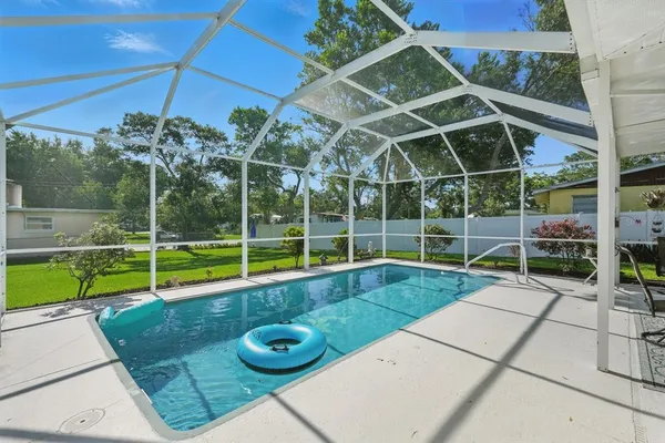 a view of a backyard with swimming pool