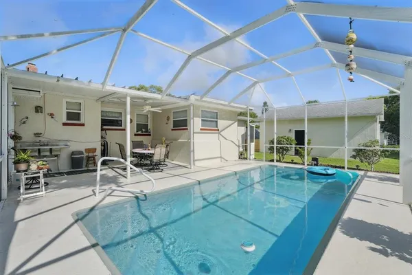 a view of a patio with table and chairs and potted plants