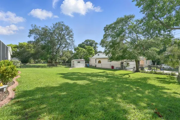 a front view of a house with a yard and trees