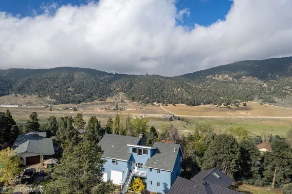 an aerial view of residential house with outdoor space and lake view