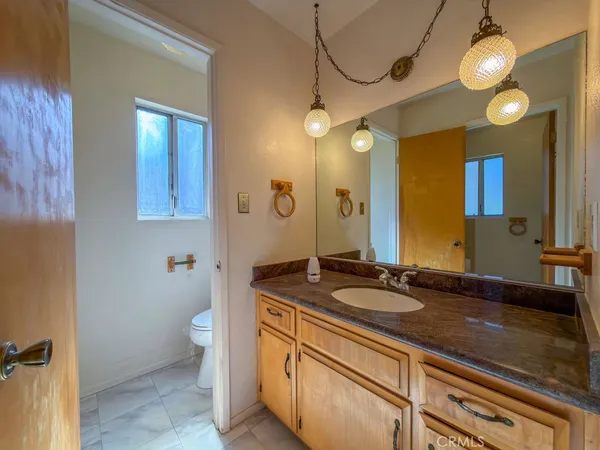 an empty room with wooden floor mirror and windows
