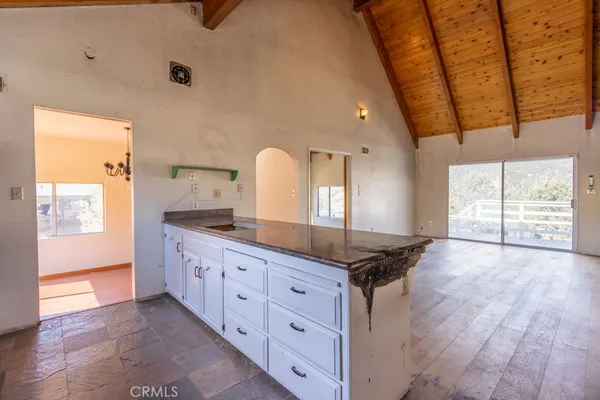 a spacious bathroom with a granite countertop sink a mirror and a shower