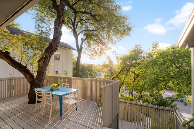 a backyard of a house with table and chairs