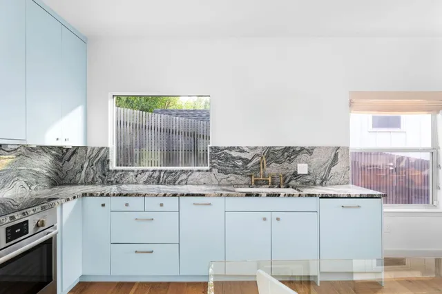 a kitchen with granite countertop a sink and a stove