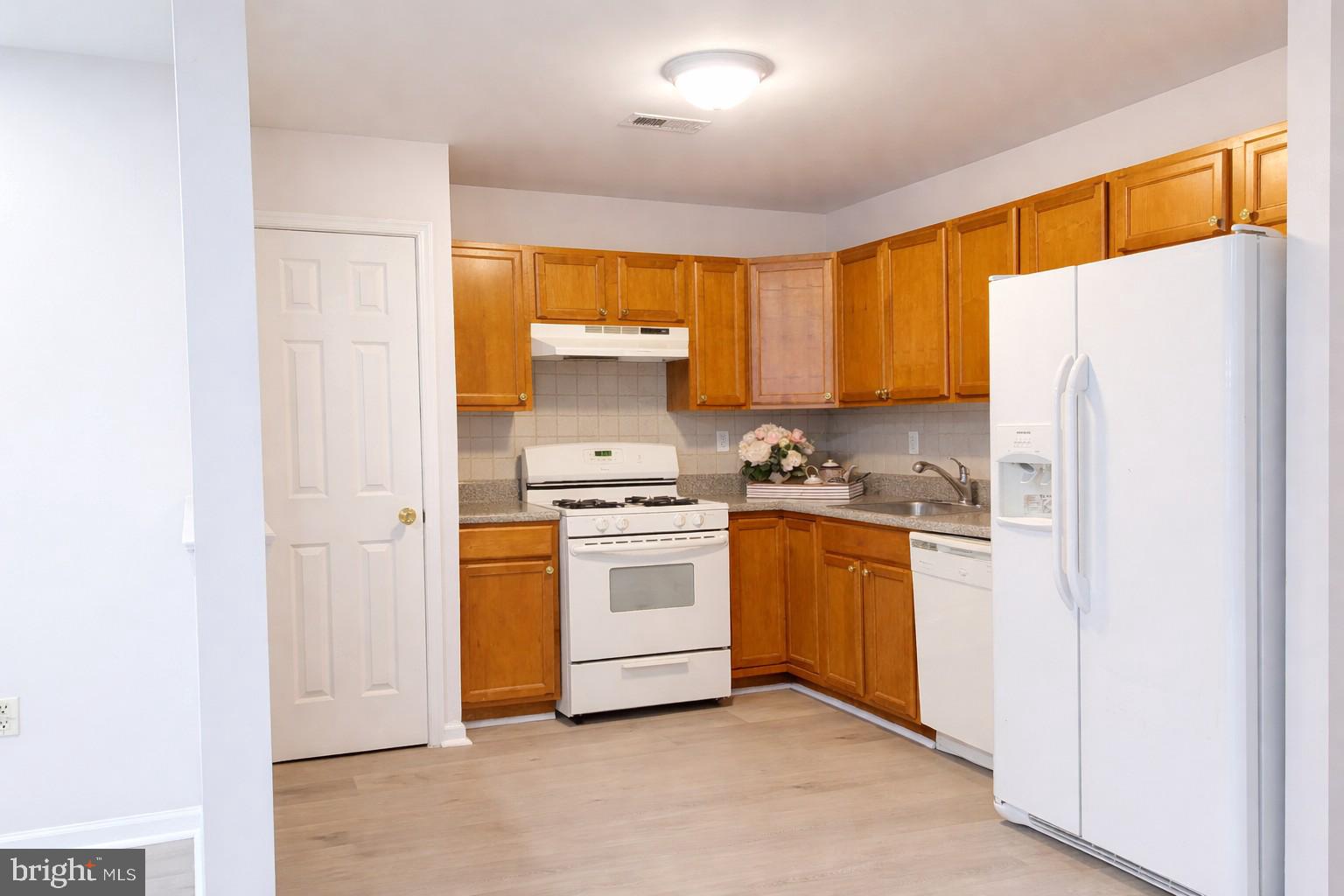 9228 Blue Grass Road, Unit 30 Philadelphia, PA 19114 - Photo 5 of 11 Modern kitchen with warm wood tones.