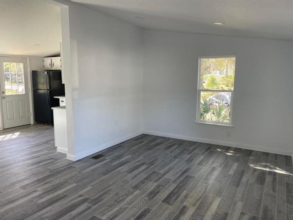1442 Spring Street St. Augustine, FL 32084 - Photo 5 of 7 wooden floor in an empty room with a window