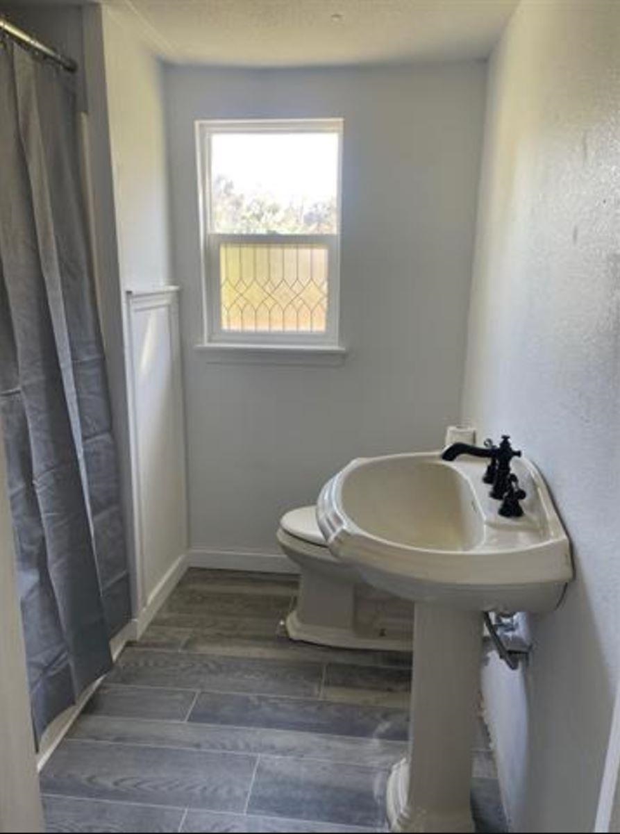 1442 Spring Street St. Augustine, FL 32084 - Photo 6 of 7 a bathroom with a sink toilet and a window