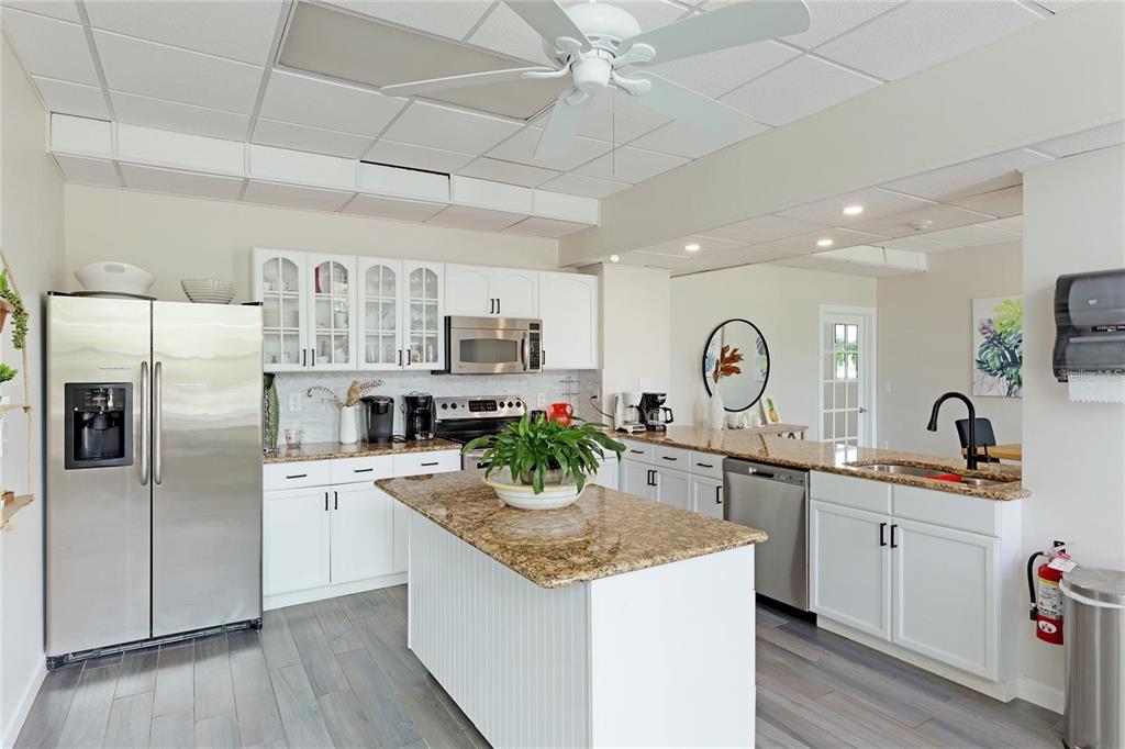 33 South Gulfstream Avenue, Unit 307 Sarasota, FL 34236 - Photo 13 of 34 a kitchen with granite countertop a sink stove and refrigerator