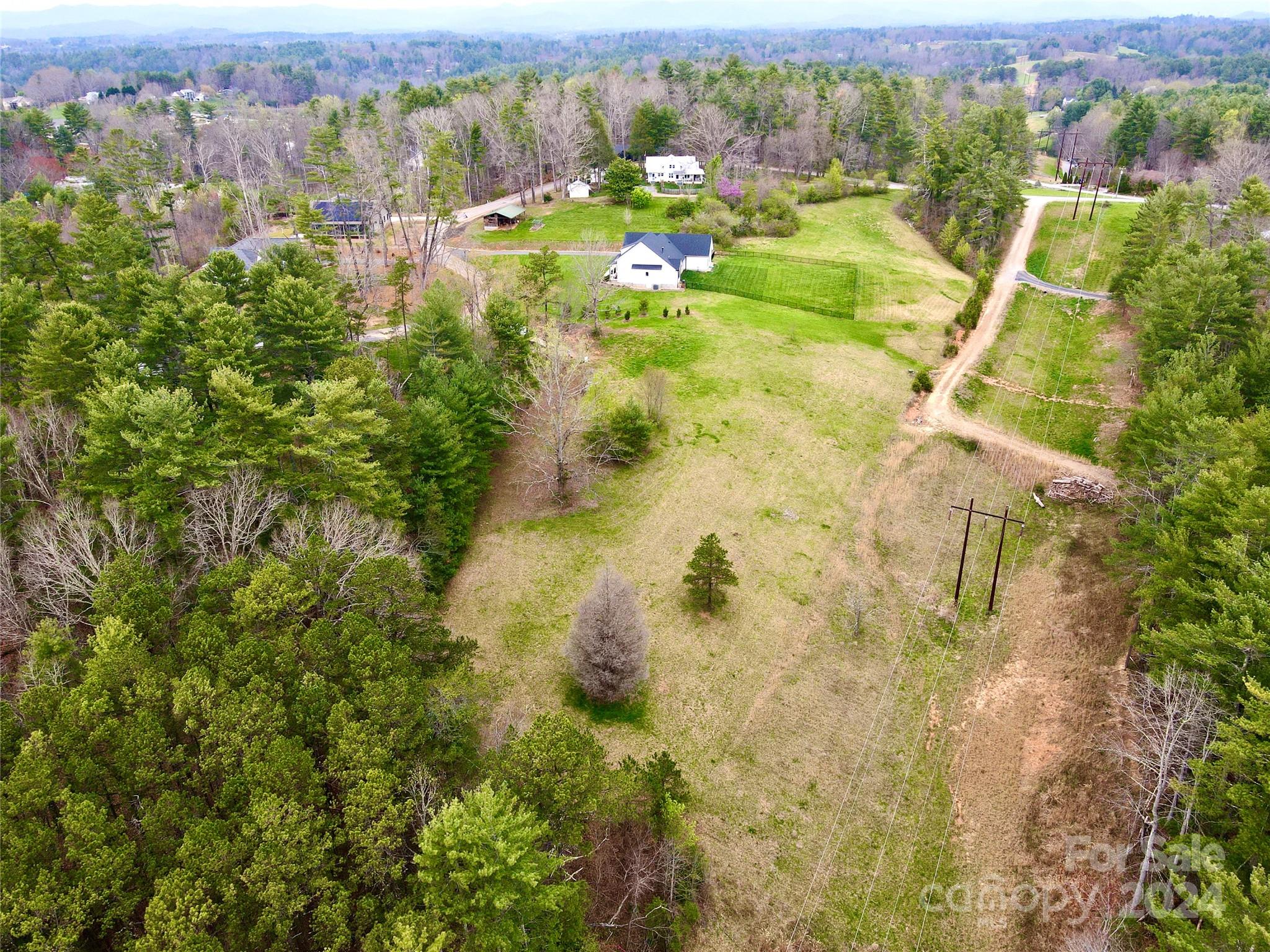 56 Tommy Ray Ridge, Unit 7 Weaverville, NC 28787 - Photo 4 of 18 an aerial view of residential houses with outdoor space and trees