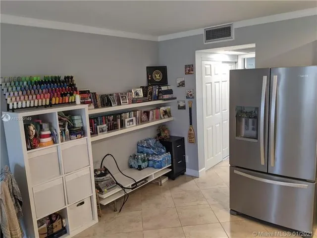 a kitchen with refrigerator and cabinets