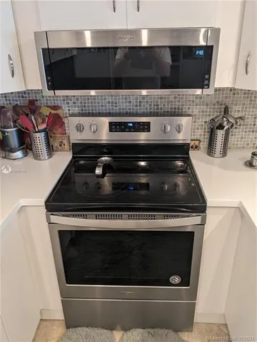 a stove top oven sitting inside of a kitchen