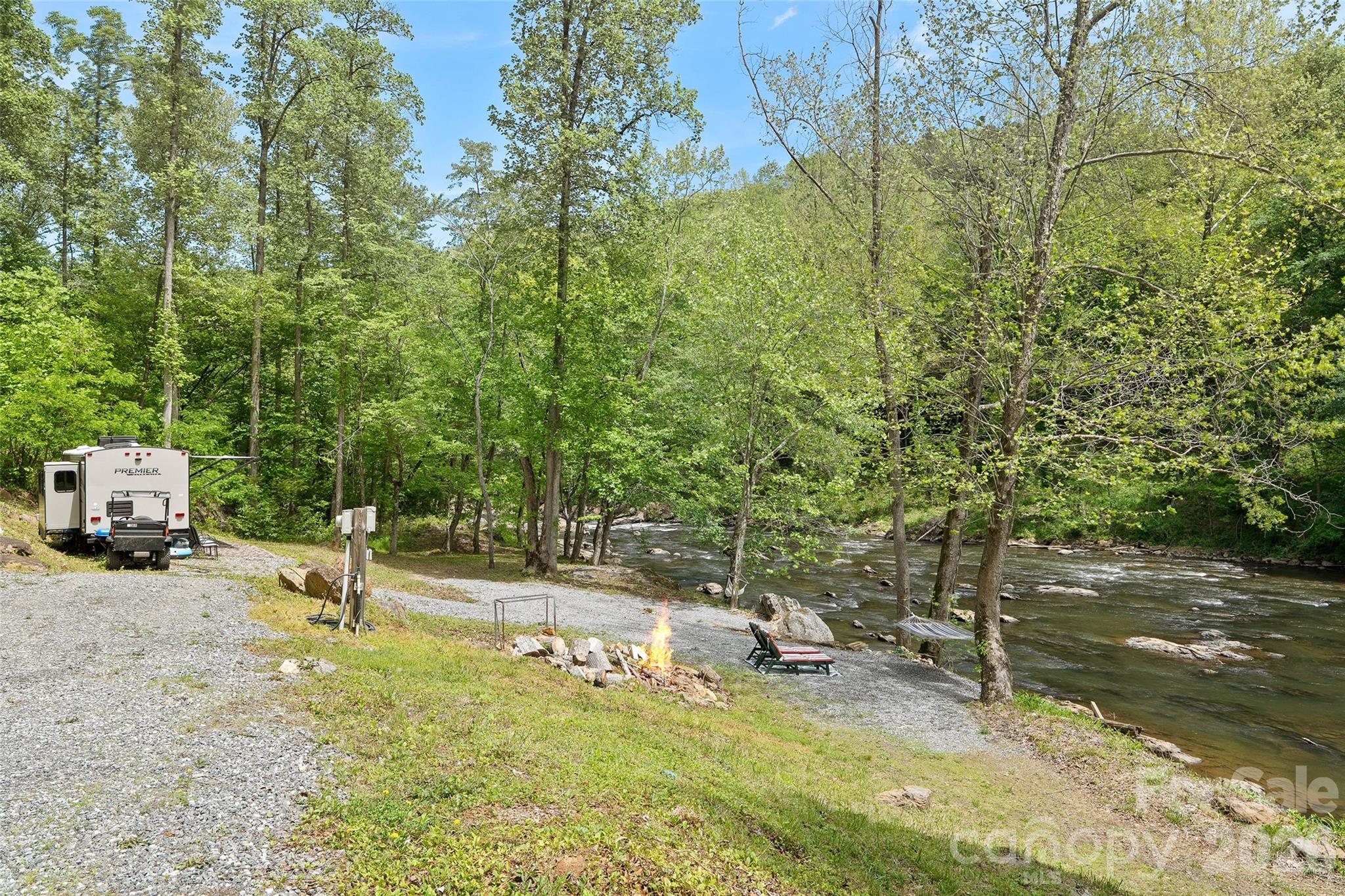 788 Cowee Tunl Road Sylva, NC 28779 - Photo 15 of 31 a backyard of a house with table and chairs