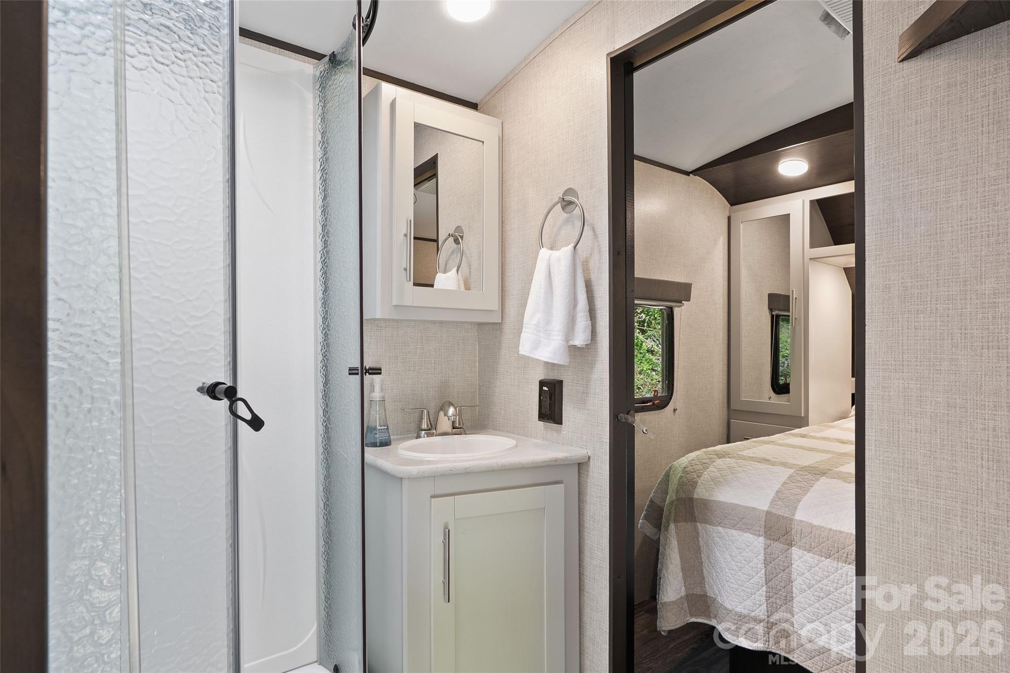 788 Cowee Tunl Road Sylva, NC 28779 - Photo 24 of 31 a bathroom with a sink a mirror and shower