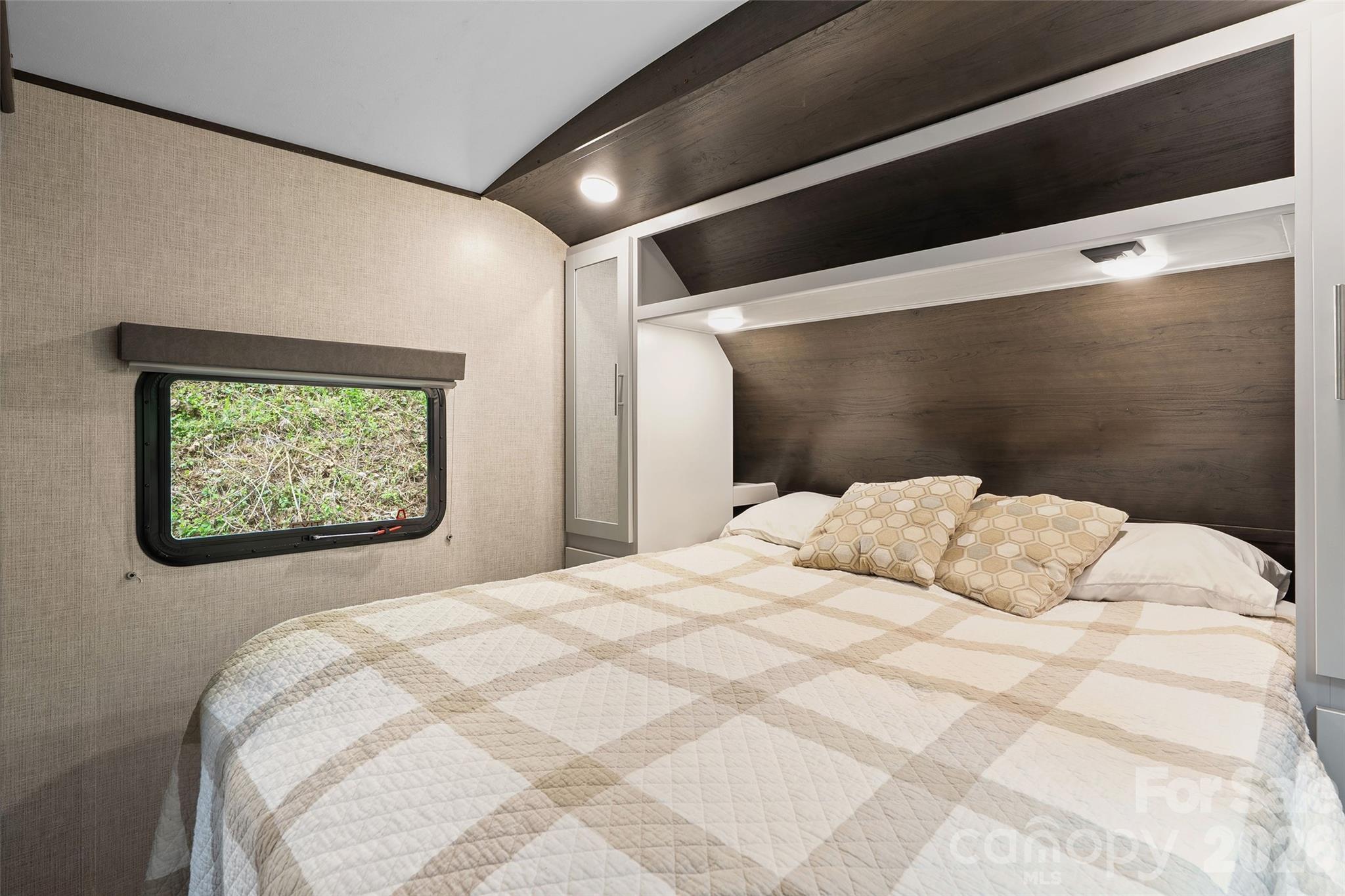788 Cowee Tunl Road Sylva, NC 28779 - Photo 25 of 31 a bedroom with a large bed and a flat screen tv