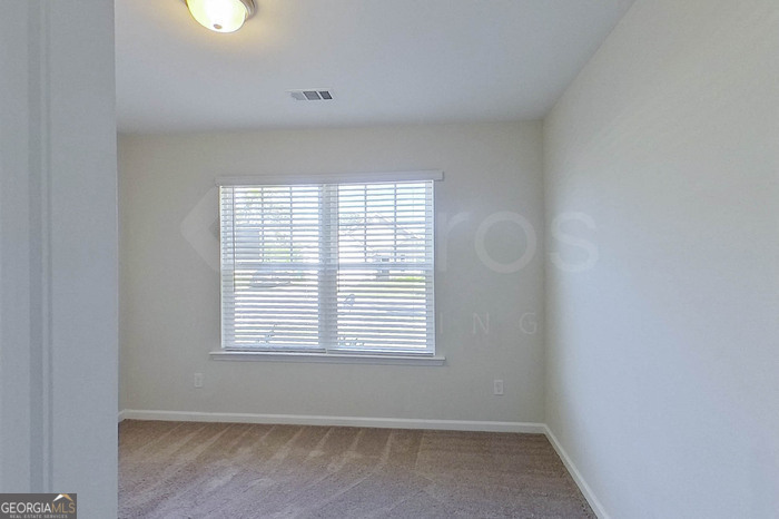 100 Ebenezer Blf Way Springfield, GA 31329 - Photo 13 of 20 a view of an empty room with a window