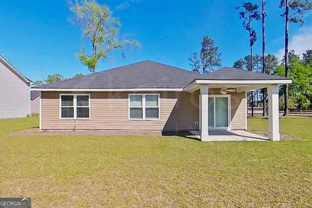 a view of a house with pool and a yard