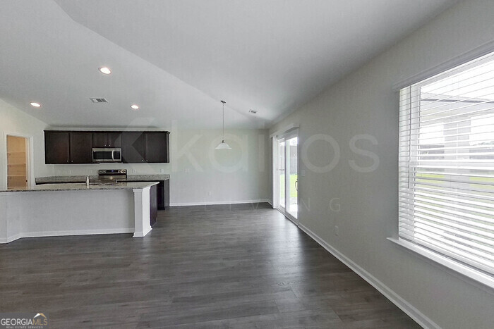 100 Ebenezer Blf Way Springfield, GA 31329 - Photo 2 of 20 a view of kitchen with microwave oven stove and white cabinets with wooden floor