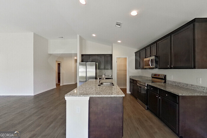 100 Ebenezer Blf Way Springfield, GA 31329 - Photo 6 of 20 a large kitchen with stainless steel appliances lots of counter top space cabinets and a center island