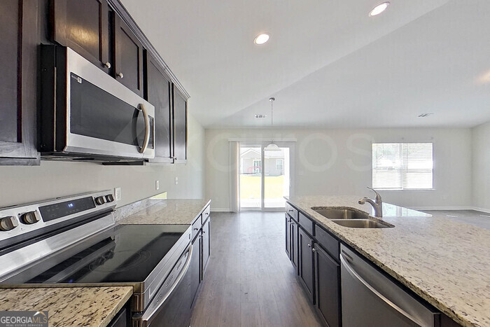 100 Ebenezer Blf Way Springfield, GA 31329 - Photo 8 of 20 a kitchen with stainless steel appliances granite countertop a sink and stove