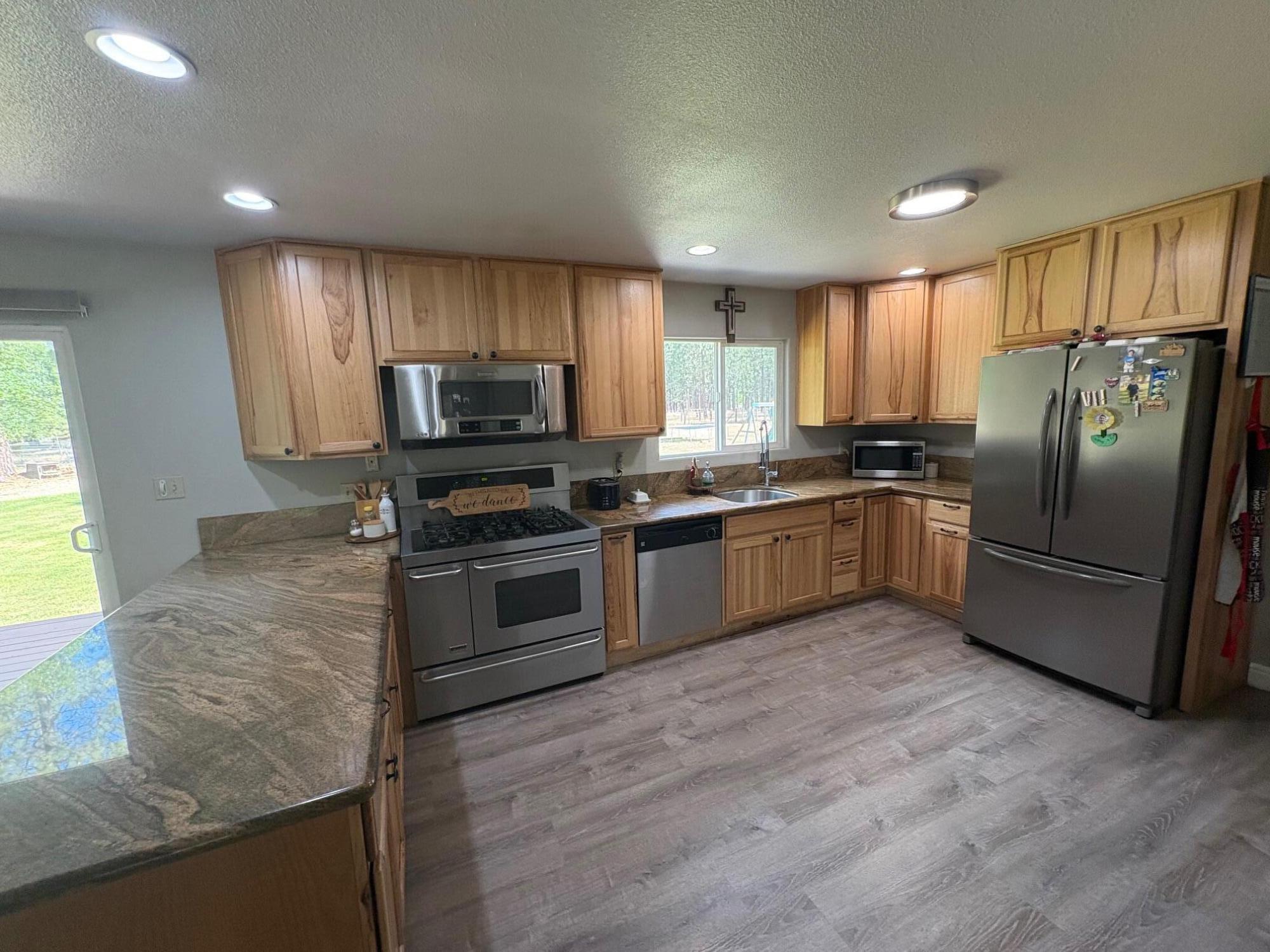 40596 Old School Road Fall River Mills, CA 96028 - Photo 14 of 29 a kitchen with granite countertop a sink stainless steel appliances and window