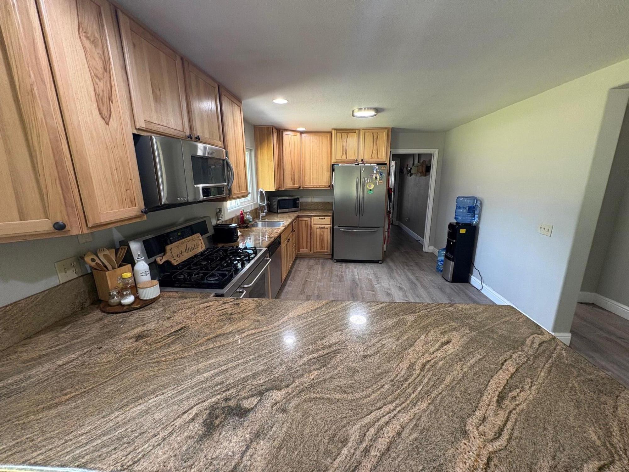 40596 Old School Road Fall River Mills, CA 96028 - Photo 18 of 29 a view of a kitchen with refrigerator and furniture