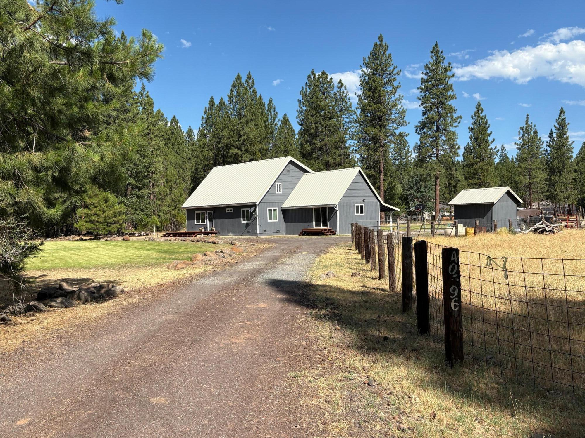 40596 Old School Road Fall River Mills, CA 96028 - Photo 2 of 29 a view of house with outdoor space and swimming pool