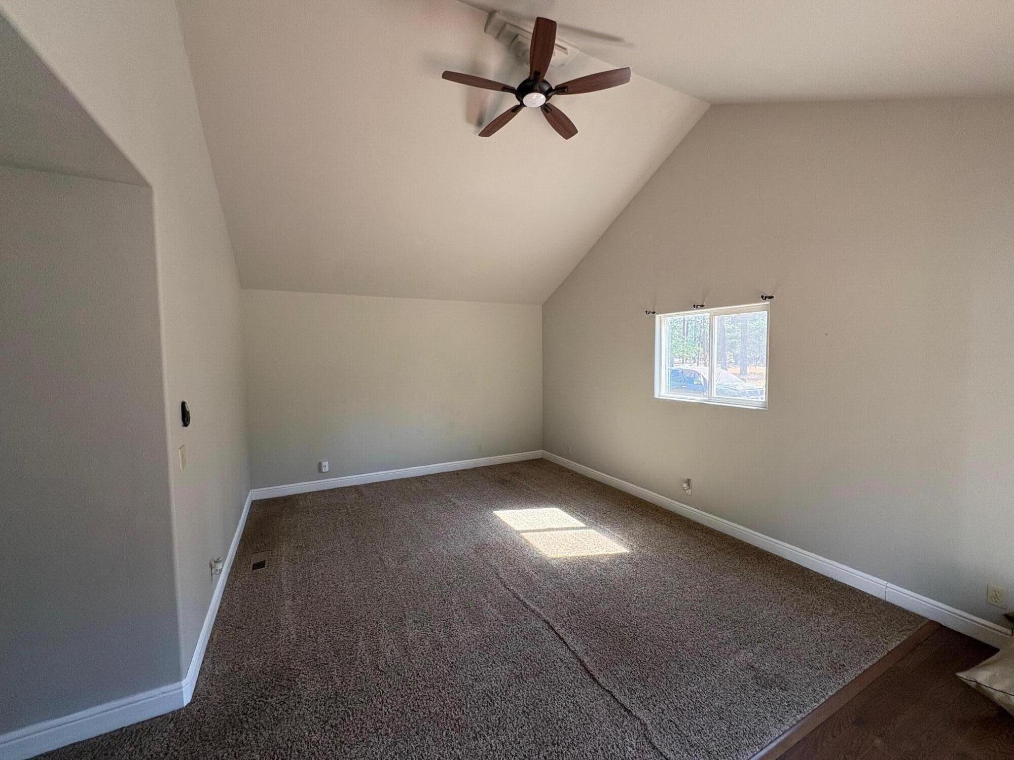 40596 Old School Road Fall River Mills, CA 96028 - Photo 22 of 29 an empty room with windows and fan