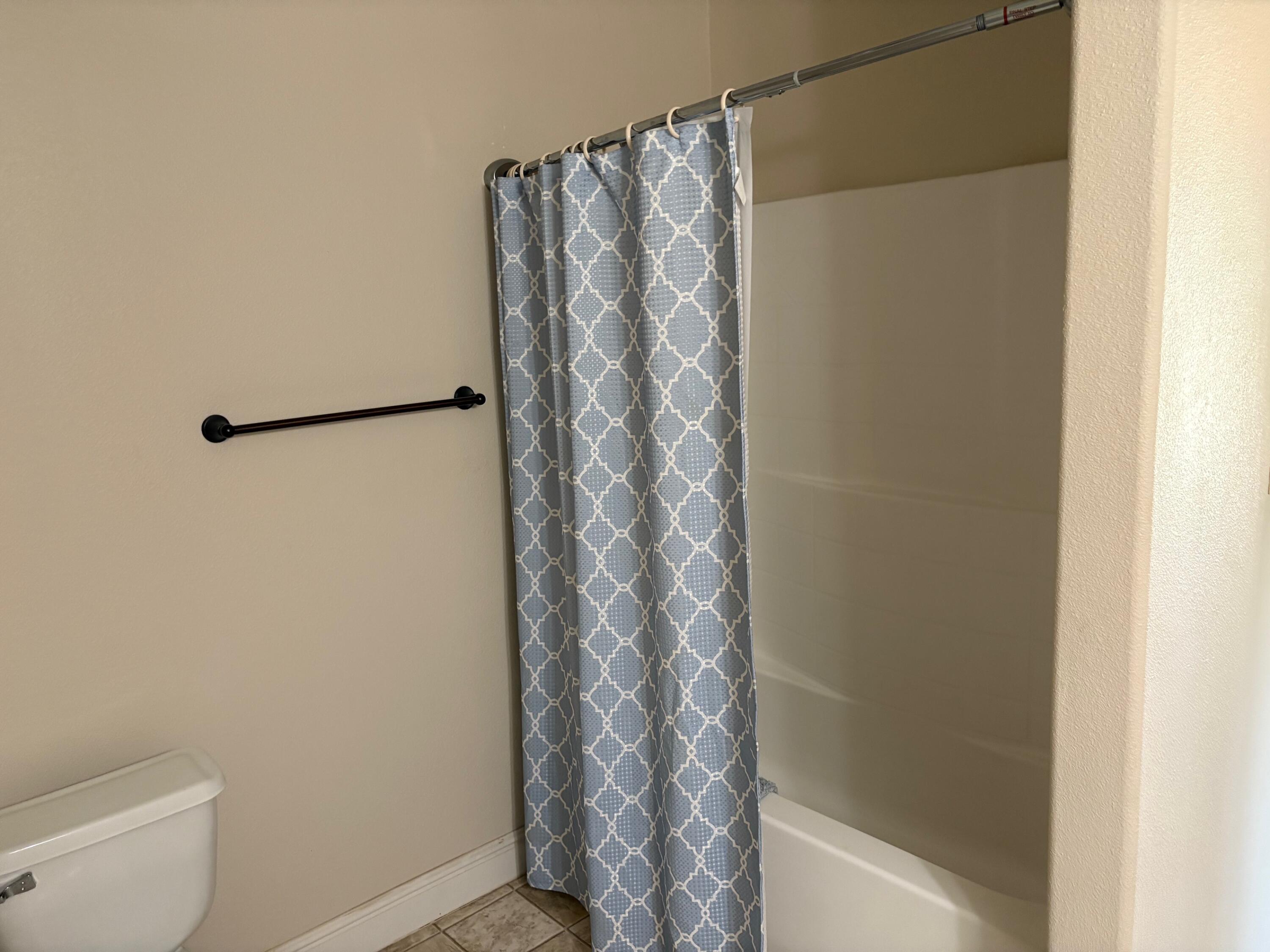 40596 Old School Road Fall River Mills, CA 96028 - Photo 27 of 29 a bathroom with a shower curtain and toilet