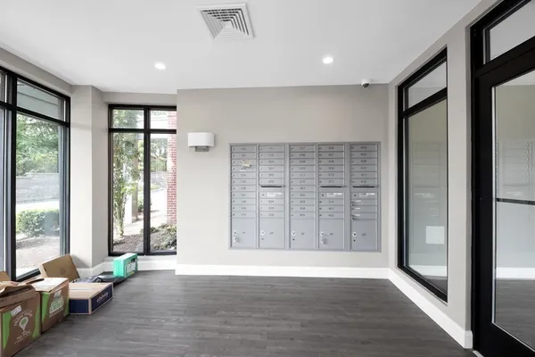 a view of an empty room with glass door and glass door