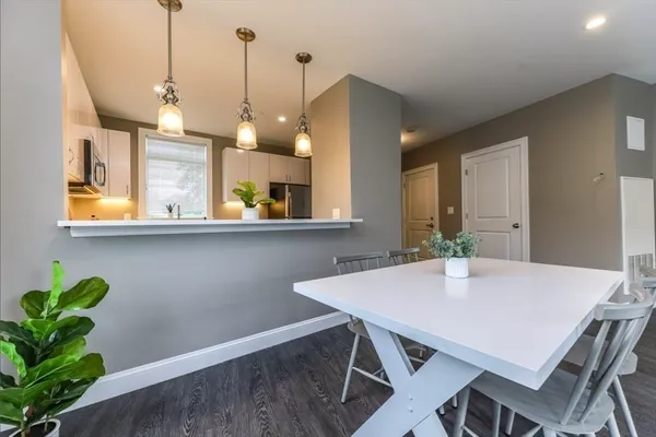 a view of a dining room with a table and chairs