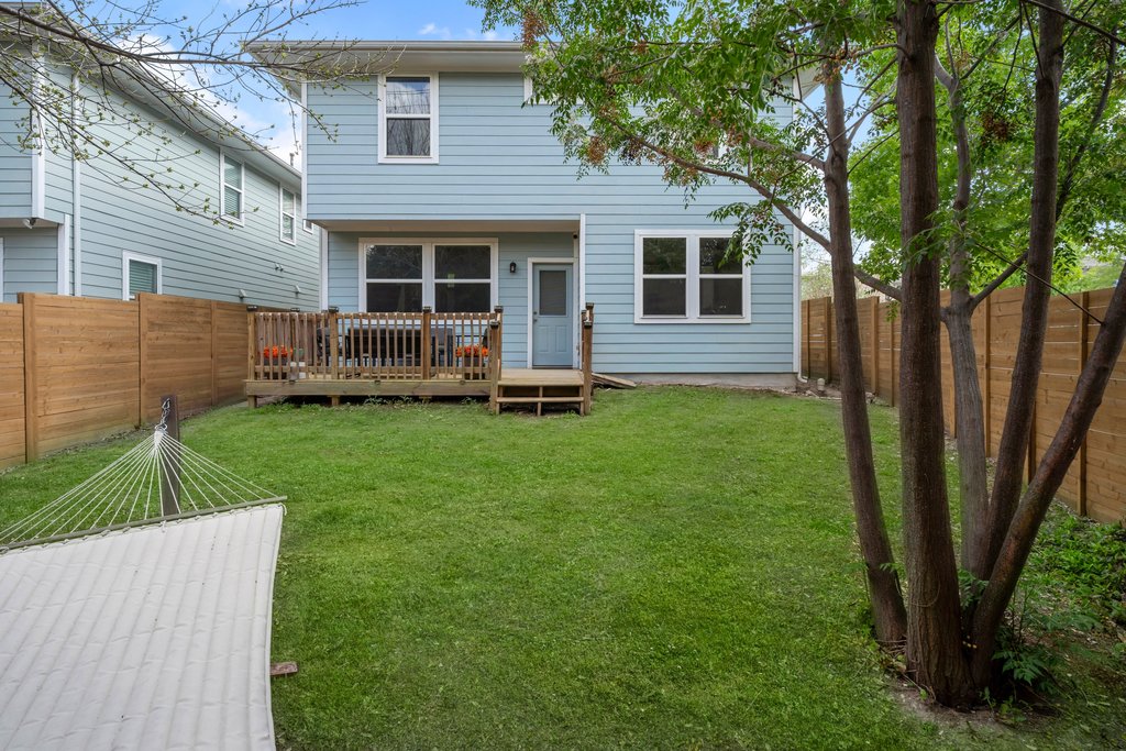 610 Bernstein Street, Unit 14 Austin, TX 78745 - Photo 35 of 39 Back of property with a wooden deck and a fenced backyard