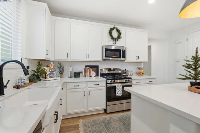 a kitchen with cabinets a sink and appliances